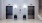 The Charley Apartments | Two stainless steel elevator doors are set in a light-colored wall at Charley Apartments in Allston MA. Each elevator has a button panel and a potted plant in front, with a staircase to the right. The floor is tiled. | Wheelchair 