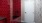 The Charley Apartments | Modern Pet Spa in Allston MA with glossy red subway tiles around a black bathtub, a white door with a silver handle, and black-and-white patterned wallpaper. The dark-tiled floor lends the space a chic vibe—perfect for an at-home 