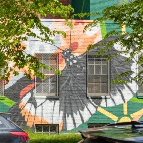A beautiful community at the heart of all your passions cars parked in front of a brick building